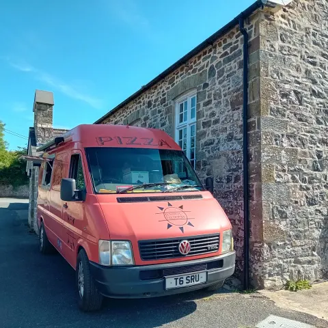 Ferdie beside an old stone chapel